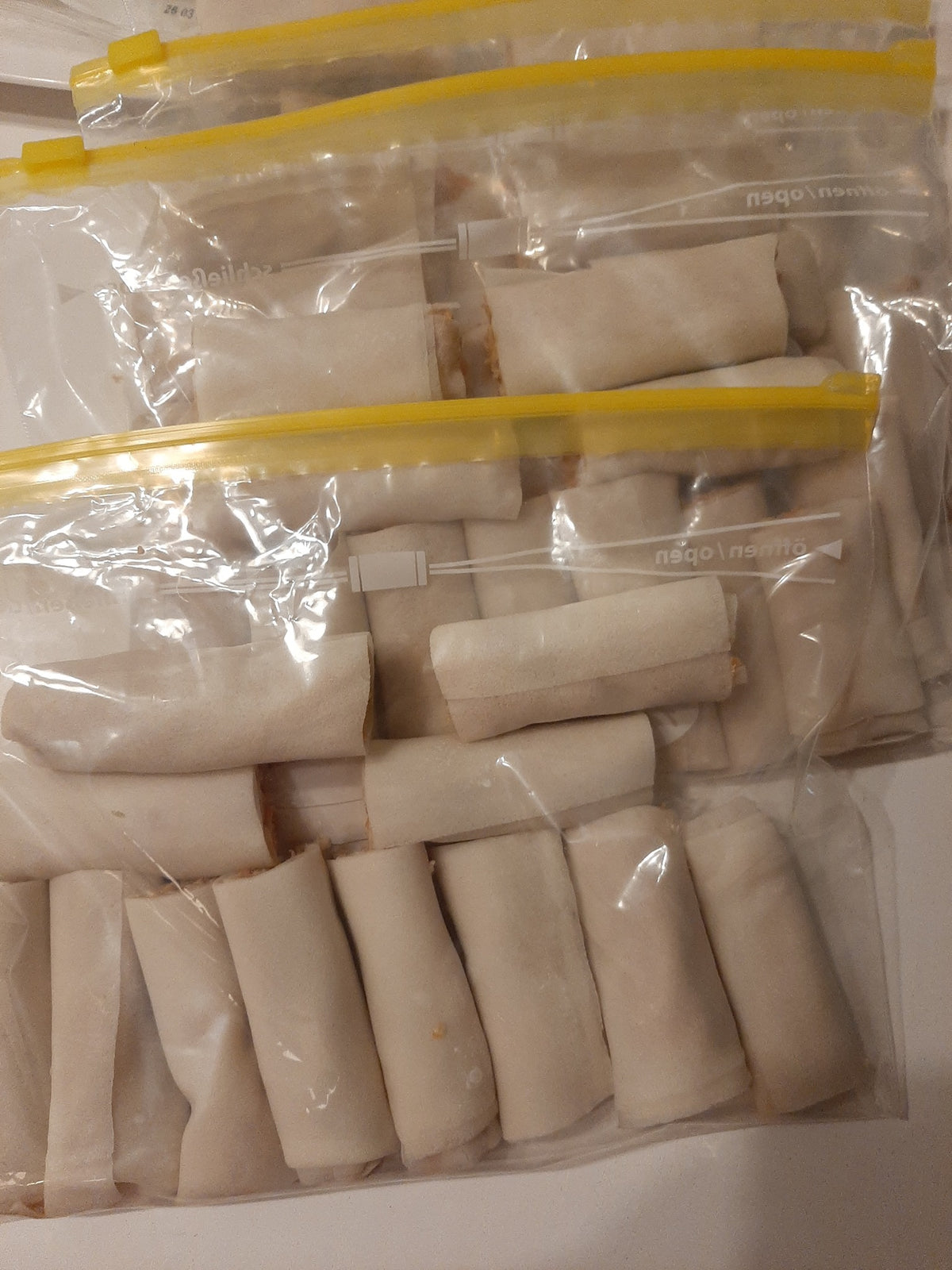 Freezer bags filled with uncooked chicken mini lumpia