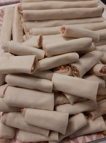 Pile of freshly rolled chicken mini lumpia before cooking