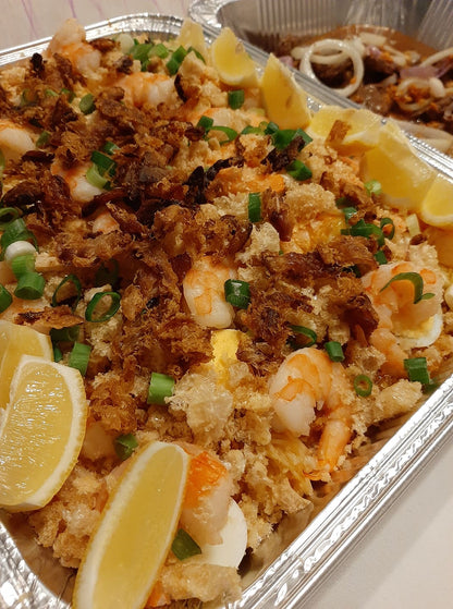 Pancit palabok noodles with shrimp, sliced eggs and toasted topping