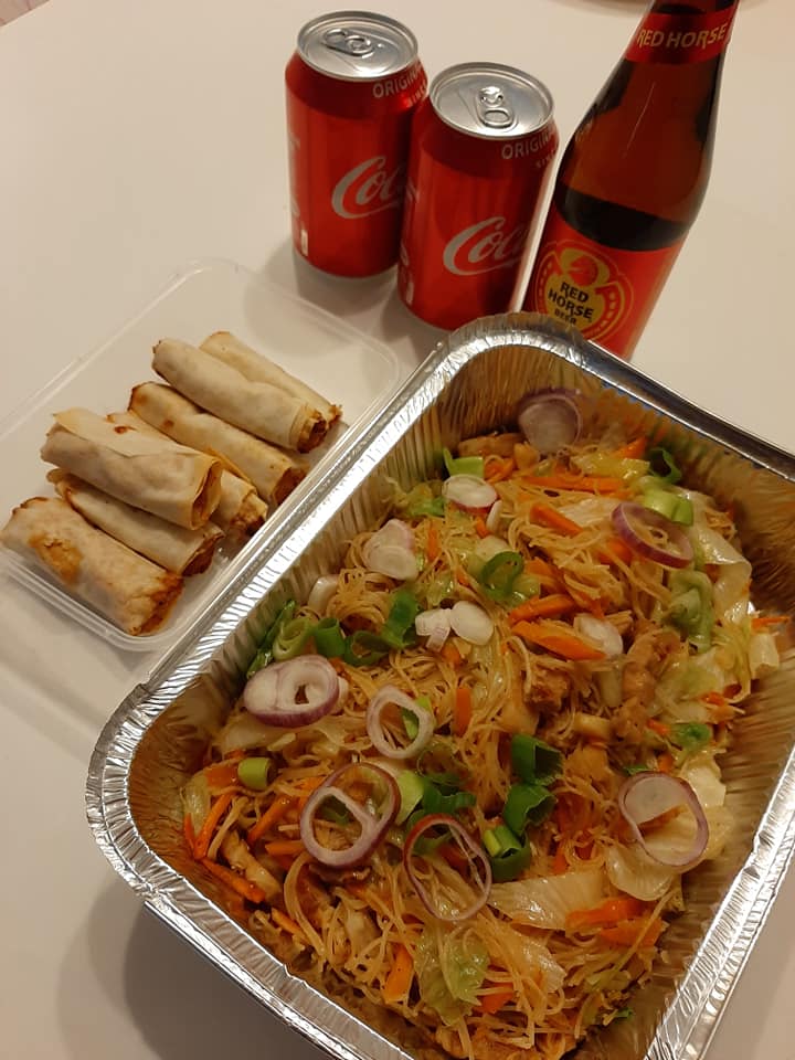 Pancit bihon party tray served with lumpia and soft drinks