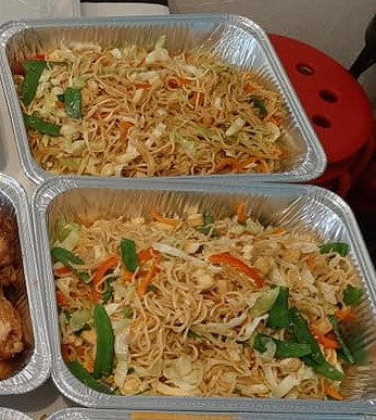Two catering trays filled with pancit Canton Guisado
