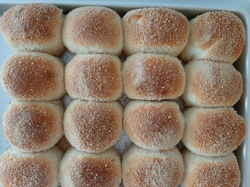 Neat rows of classic pandesal with golden tops