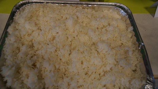 Large foil tray filled with freshly cooked plain white rice