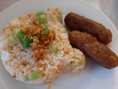 Cooked skinless chicken longganisa served beside garlic rice