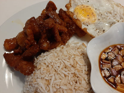 Close-up of glazed chicken tocino served with rice, egg and dipping sauce