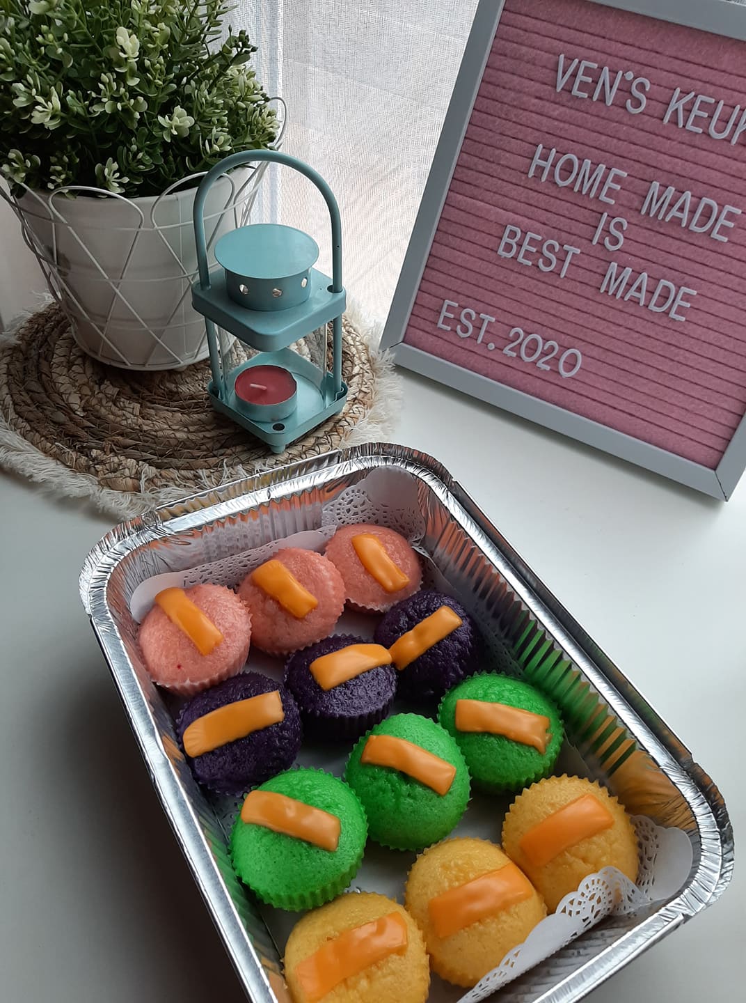 Angled view of assorted puto cheese in a foil catering tray