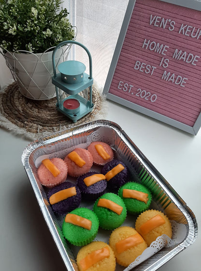Angled view of assorted puto cheese in a foil catering tray