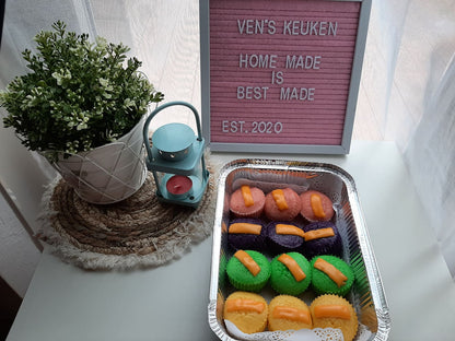Tray of colourful puto cheese displayed beside a Ven's Keuken sign
