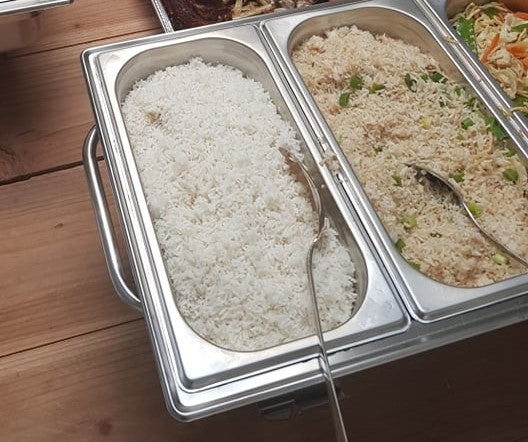 Buffet pans of plain rice and garlic rice ready for serving