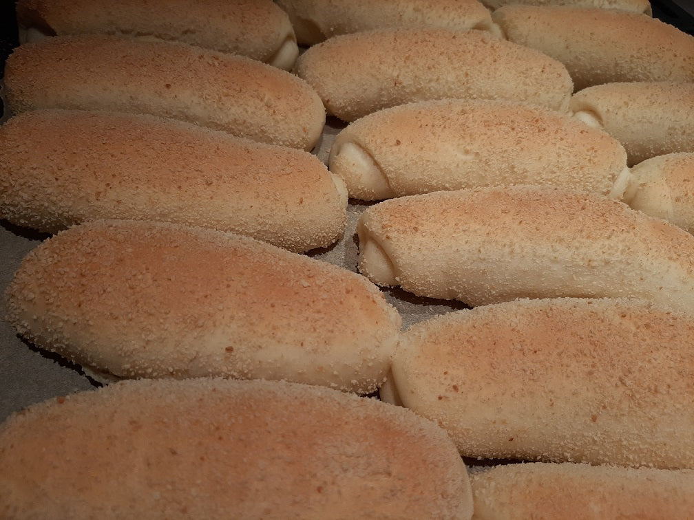 Close-up rows of soft Filipino Spanish bread rolls