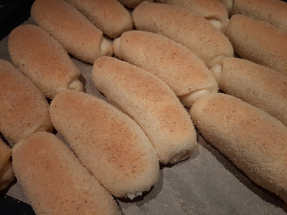 Batch of Spanish bread rolls cooling on baking paper